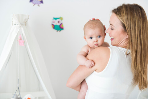 Mutter und Baby im Kinderzimmer, lizenzfreies Stockfoto