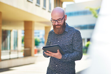 Bearded man using digital tablet - CUF45948