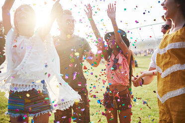 Five young adult friends throwing confetti at Holi Festival - CUF45955