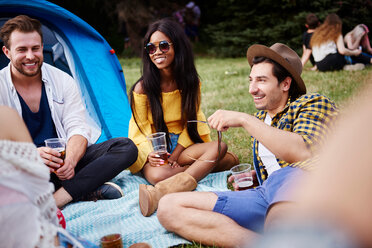 Friends sitting and enjoying music festival - CUF46018