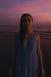 Portrait of young woman in front of the sea by sunset - MAUF01730