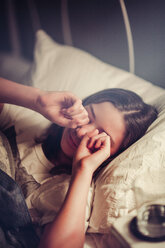 Girl rubbing eyes in bed - ISF19667