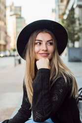 Portrait of woman wearing hat, hand on chin looking away, New York, USA - ISF19844