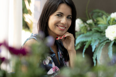 Portrait of smiling dark-haired woman at home - HHLMF00520