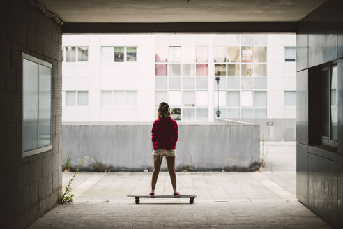 Young woman with her long board in a residential area - RAEF02174