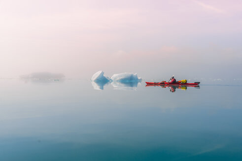 Man sea kayaking in fjord, Narsaq, Kitaa, Greenland - CUF46053