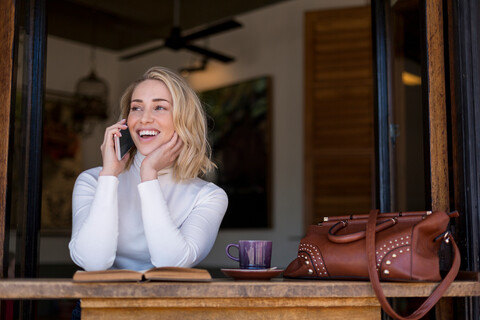 Frau am Mobiltelefon in einem Café, Kapstadt, Südafrika, lizenzfreies Stockfoto