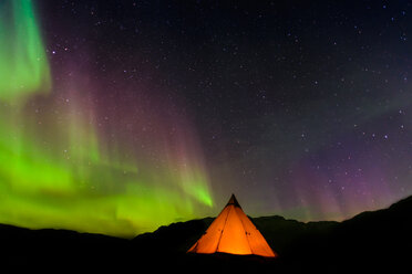 Lit up tent, Aurora Borealis in background, Narsaq, Vestgronland, Greenland - CUF46077