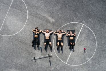 Group of young people in good shape, training on a sportsfield - HMEF00030