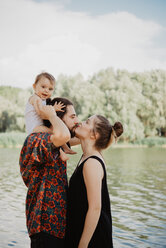 Couple with baby girl by lake, Arezzo, Tuscany, Italy - CUF46193