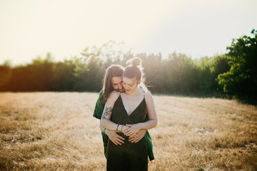 Couple on golden grass field, Arezzo, Tuscany, Italy - CUF46206