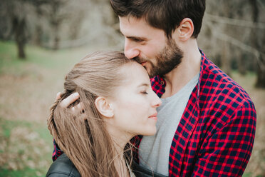 Couple hugging in park - CUF46240