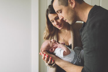 New parents admiring new born baby boy - CUF46297