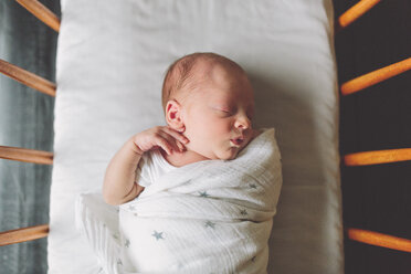 New born baby boy swaddled in cot, overhead view - CUF46299