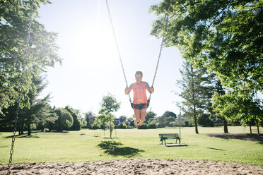 Girl on swing in playground, Kingston, Canada - CUF46312