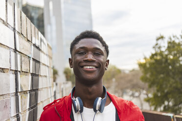 Young black man with headphones, smiling, portrait - AFVF01817