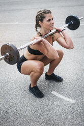 Woman doing barbell exercise during weight lifting workout - HMEF00037