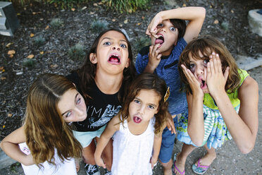 High angle portrait of siblings making faces while standing at park - CAVF49115