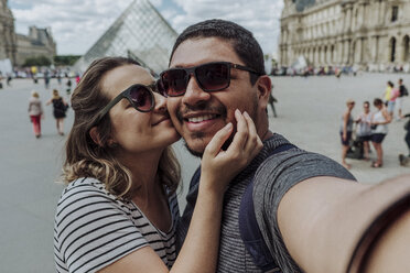 Porträt einer Freundin, die ihren Freund küsst, vor dem Musee du Louvre in der Stadt - CAVF49134