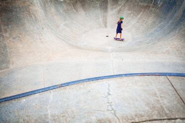 High angle view of girl skateboarding on sports ramp at park - CAVF49299