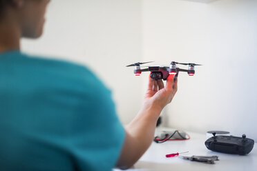 Boy repairing drone - DIGF05129