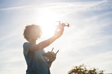 Boy flying a drone outdoors - DIGF05130