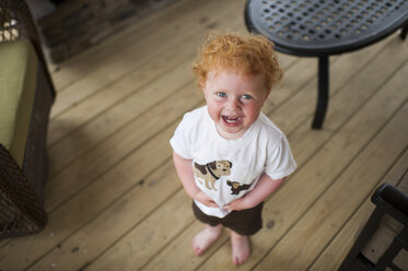 Hohe Winkel Porträt der glücklichen niedlichen Baby Junge steht auf Hartholzboden zu Hause - CAVF49398
