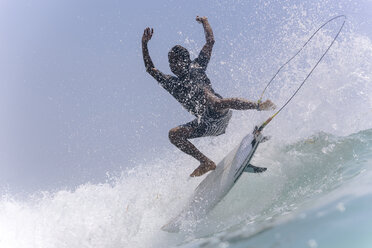 Full length of man surfing in sea against sky - CAVF49567
