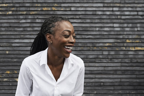 Portrait of laughing businesswoman wearing white shirt - IGGF00665