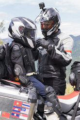 Vater und Sohn machen eine Pause während einer Motorradtour - FBAF00143