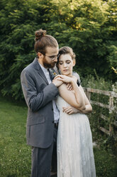 Bride embracing groom on a meadow - ALBF00675