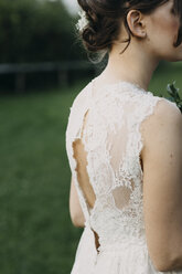 Close-up of young woman wearing wedding dress outdoors - ALBF00681