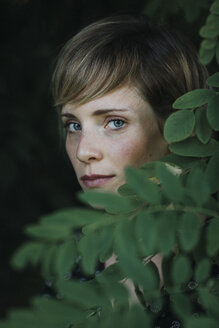 Portrait of a woman behind leaves - ALBF00682