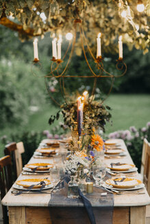 Festive laid table with candles outdoors - ALBF00700