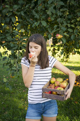 Girl eating freshly harvested apple - LVF07483