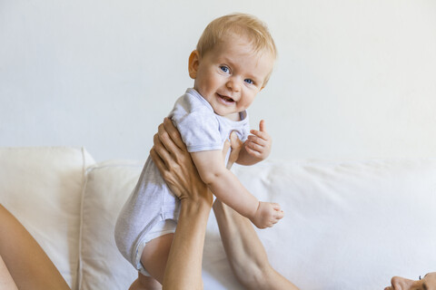 Portrait of happy baby girl held by her mother stock photo