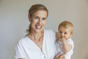 Portrait of happy mother holding her baby girl - TCF05891