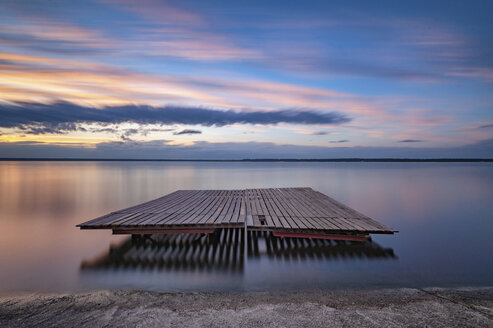 Wooden raft on calm lake against sky during sunset - CAVF49775