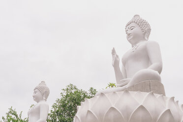 Low angle view of Buddha statues against clear sky - CAVF49810