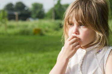 Close-up of cute thoughtful girl looking away at farm - CAVF49822