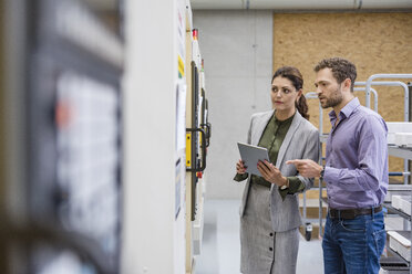 Businessman and woman having a meeting in high tech company - DIGF05210