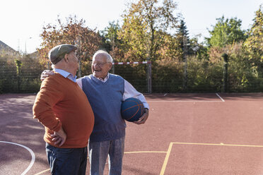 Zwei fitte Senioren haben Spaß auf einem Basketballfeld - UUF15547