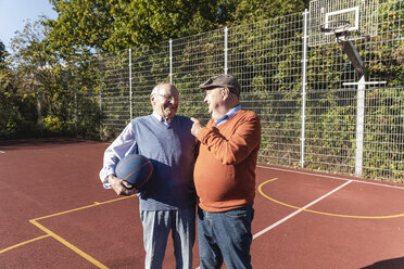 Zwei fitte Senioren haben Spaß auf einem Basketballfeld - UUF15548