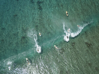 Aerial view of people surfing on sea at Maldives during sunny day - CAVF50166