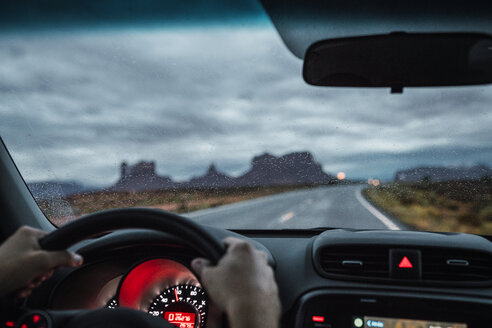 USA, Utah, Car driving to Monument Valley under a stormy sky - KKAF02549