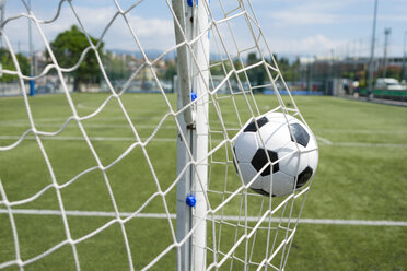 Soccer ball hitting net against sky - CAVF50548