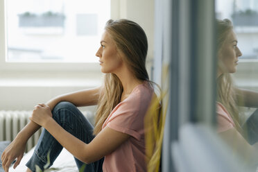 Young woman relaxing at home - KNSF05003