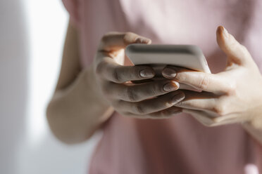 Hands of young woman text messaging, close-up - KNSF05031