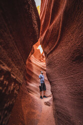 USA, Arizona, tourist standing in Lower Antelope Canyon - KKAF02551