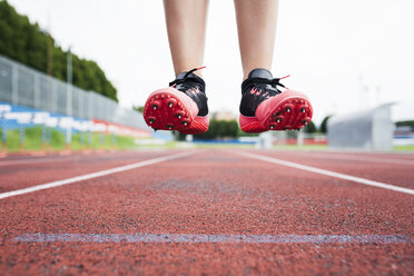 Feet of a jumping runner, mid air - GIOF04791